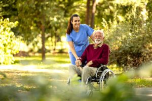 Older adult and family member reviewing home care and assisted living expenses at a kitchen table.